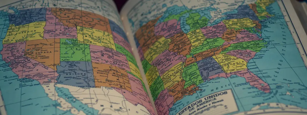 An open atlas shows a colorful map of the United States, for criminal justice rankings by state.